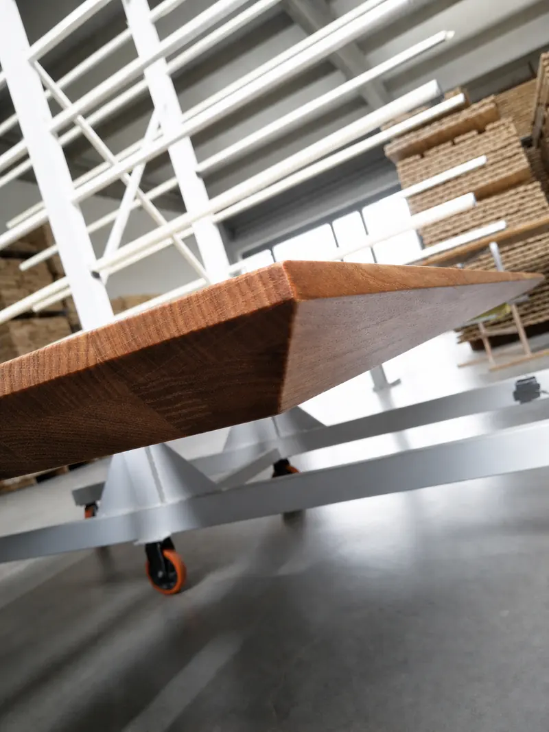 Precision-machined curved hardwood profile shown on production equipment
