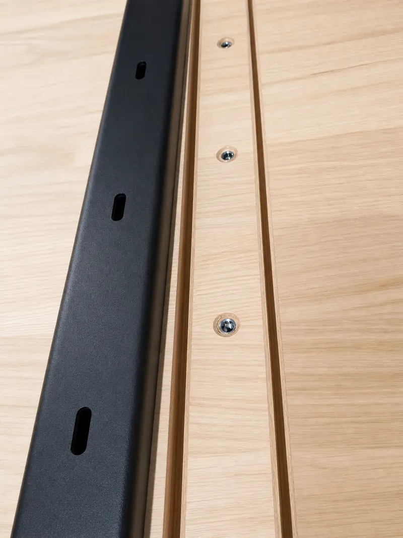 Close technical view of a fitted black rail and clean fastener alignment