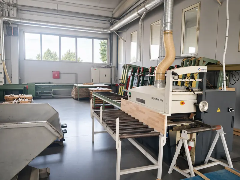 Professionally lit panel-processing line inside the Pašinac production hall